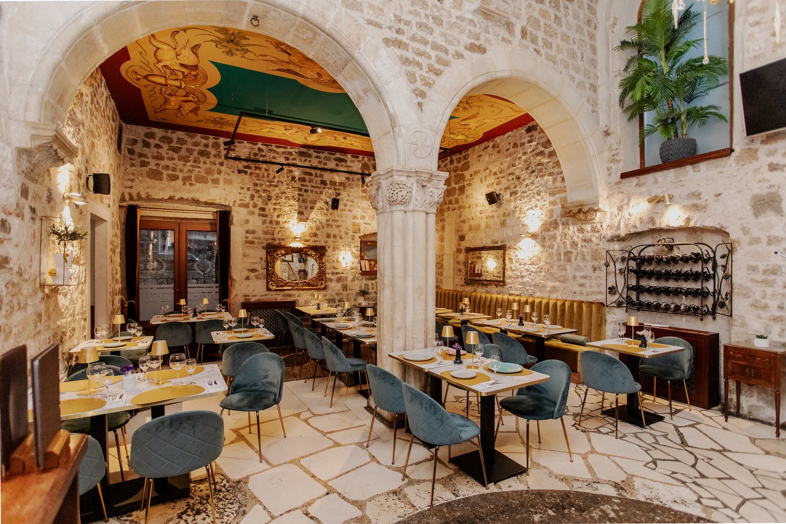 Lvxor restaurant interior — stone arches and painted vaulted ceiling