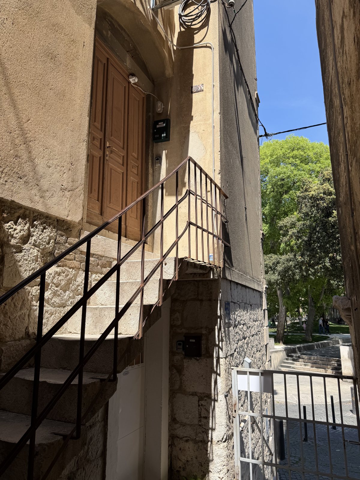 Narrow stone stairs leading to the wooden building entrance